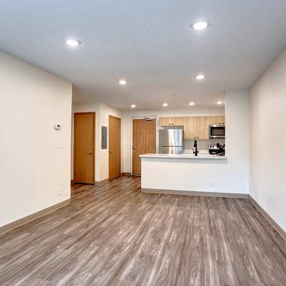 a room with wooden floors and white walls.