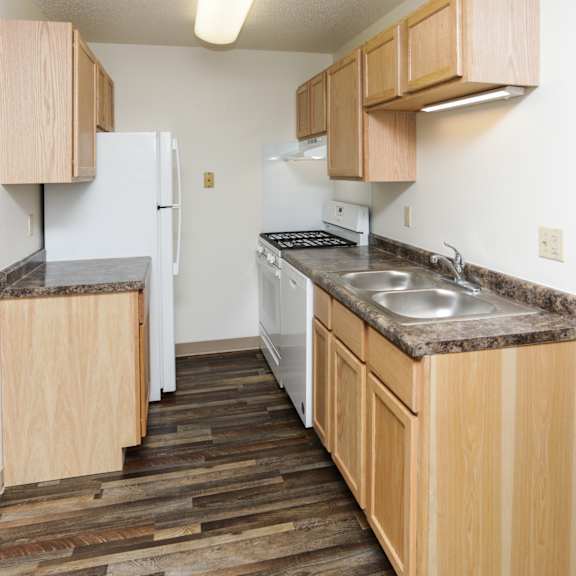 a kitchen with wooden cabinets and a granite countertop.