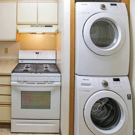 a white oven and microwave are on a kitchen counter.