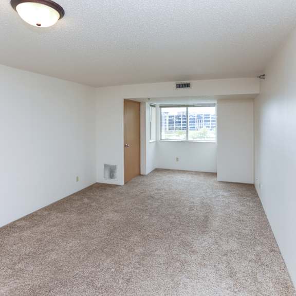 a room with a carpeted floor and a ceiling light.