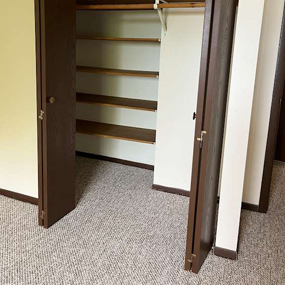 a brown shelf with a glass panel on top.