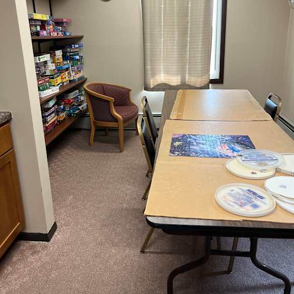 a room with a cork board and a clock on the wall.