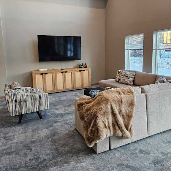 a living room with a large couch and a television.