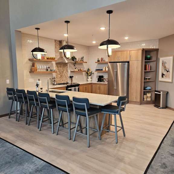a modern kitchen with a long table and chairs.