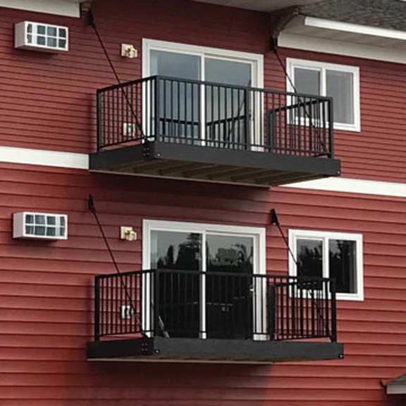 a red building with a black balcony.