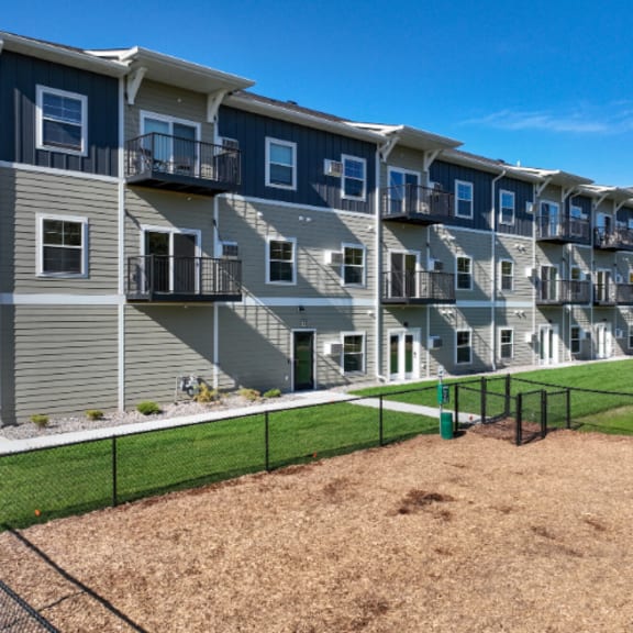 apartment complex with a sandbox in front.