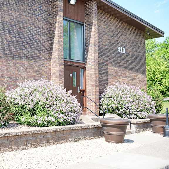 a brick building with a brown door and windows.