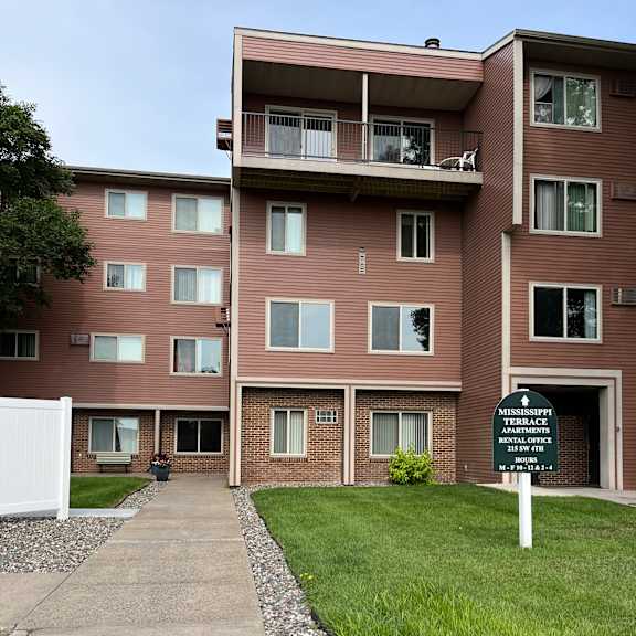 a brown building with a white refrigerator in front of it.