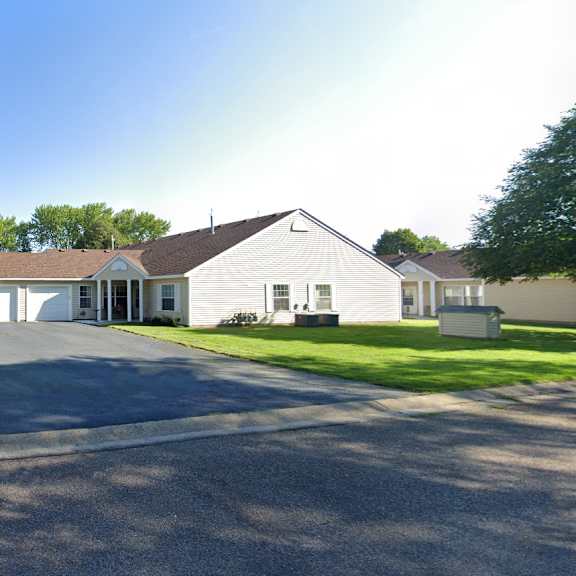 a white house with a driveway and a garage door