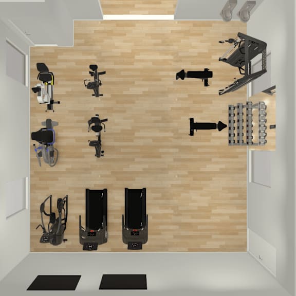 a top-down view of a room with a wooden floor and white walls, containing a variety of exercise equipment.