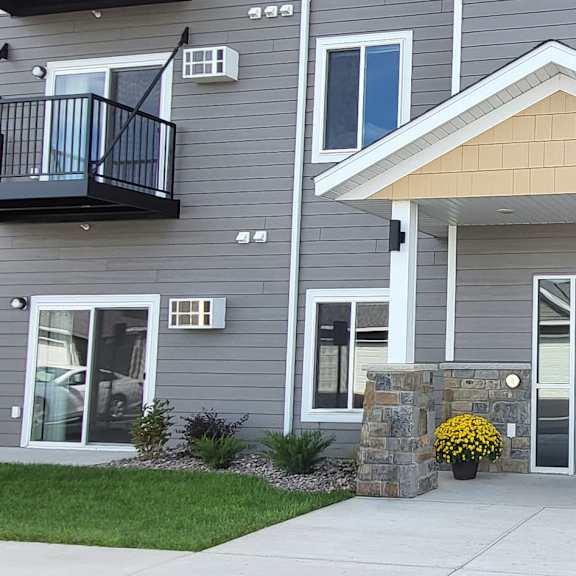 a grey apartment  with a door and windows.
