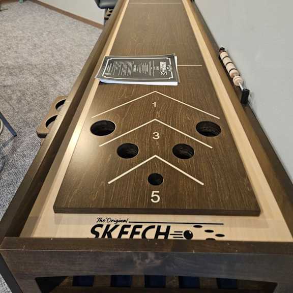 a shuffleboard table with the word skeech on it.