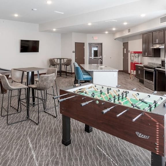 a game room with two pool tables and a bar