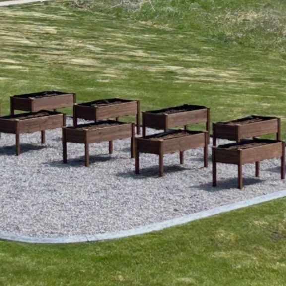 a set of eight chairs are arranged in a circle on a gravel area.