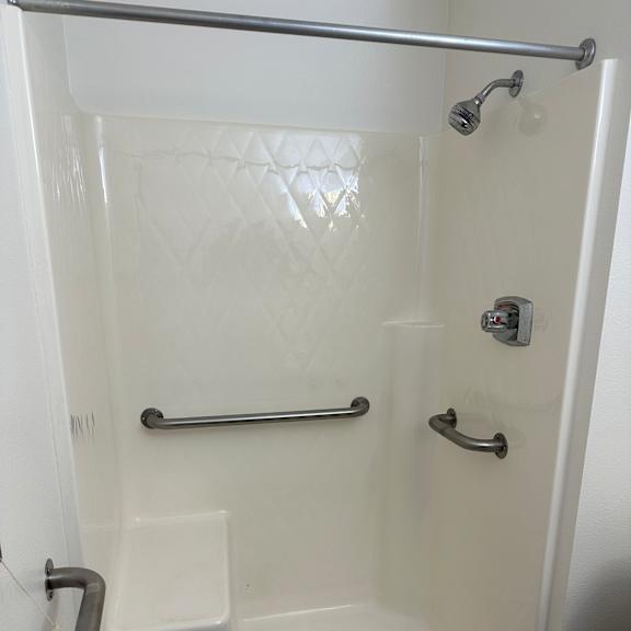 a bathroom with a tub and a toilet and a sink