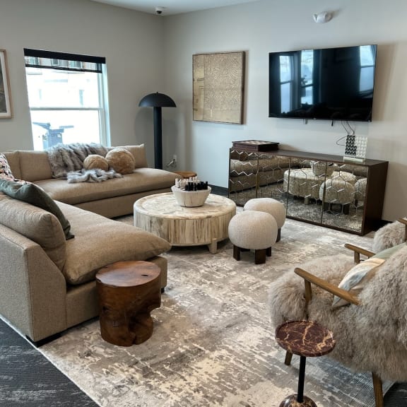 a living room with couches and chairs and a tv