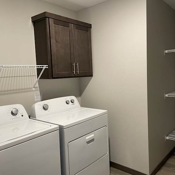 a laundry room with a washer and dryer and a closet