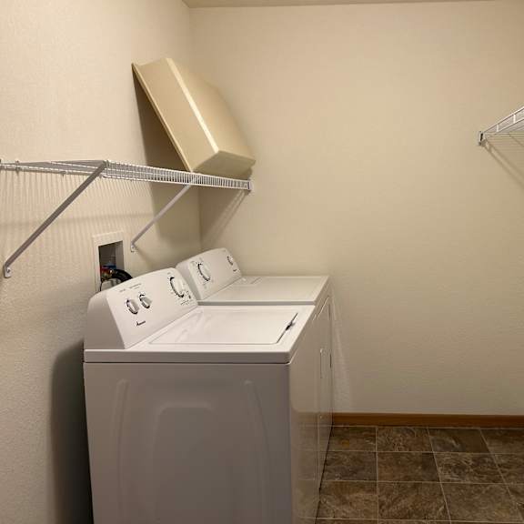 a small laundry room with a washer and dryer.
