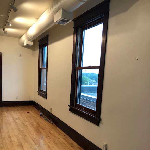 a room with a skylight and a wooden wall.