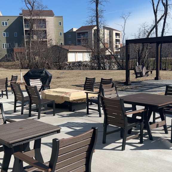 a patio with tables and chairs is empty.