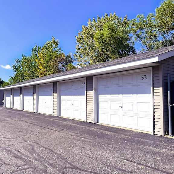 a row of white garage doors are numbered 53 and 52.