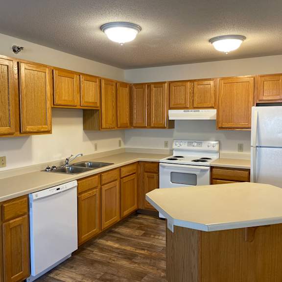 a kitchen with wooden cabinets and a white refrigerator.
