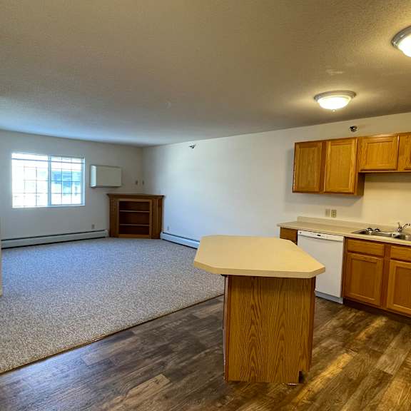 a kitchen with wooden cabinets and a white countertop.