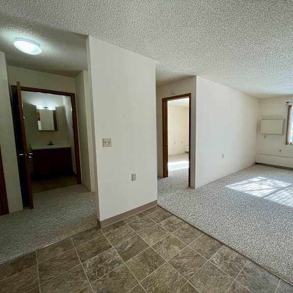 a room with a large window and a tiled floor.