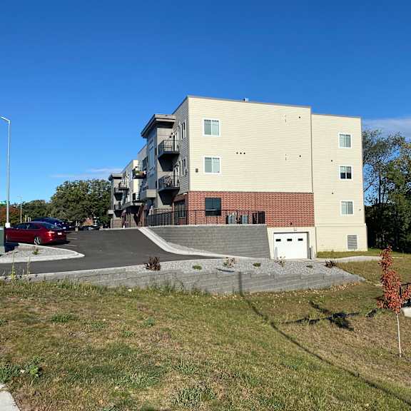 an apartment building with a car parked in front of it