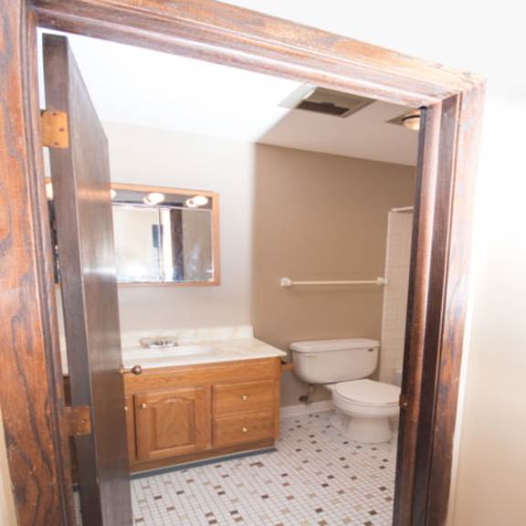 bathroom with large vanity, toilet, and shower