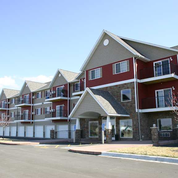 apartment complex with red and beige buildings.