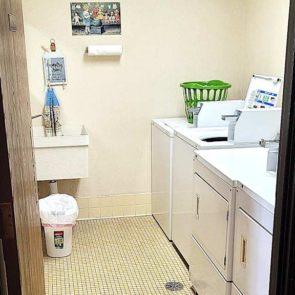 a bathroom with a white sink and a white toilet.