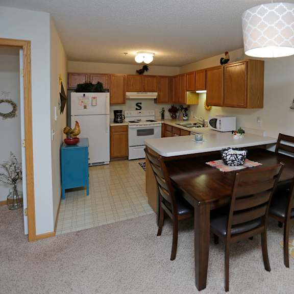 an open kitchen and dining room with a table and chairs