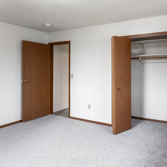 a room with a closet and a door.