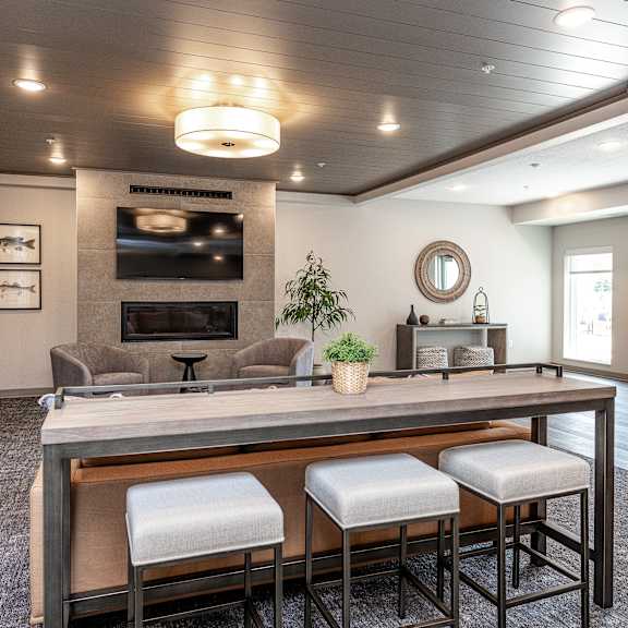 a modern dining room with a long table and chairs.