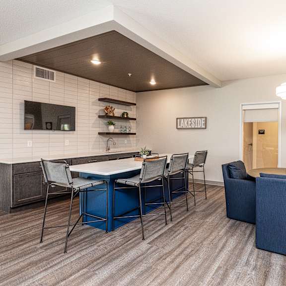 a dining room with a blue table and chairs.