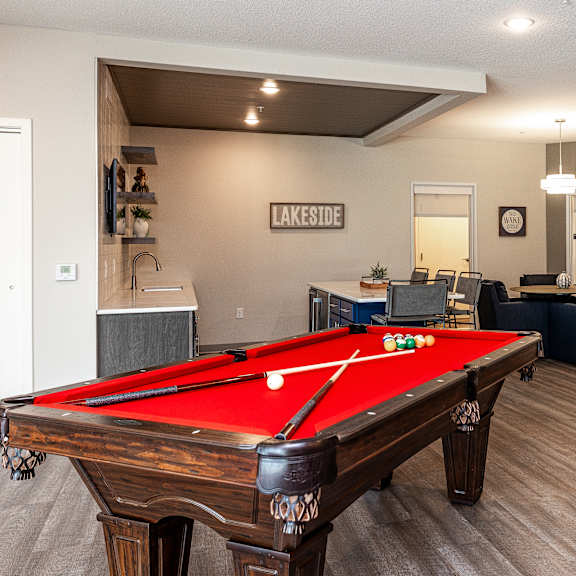 a pool table in a room with a sign that says "lakeside.".