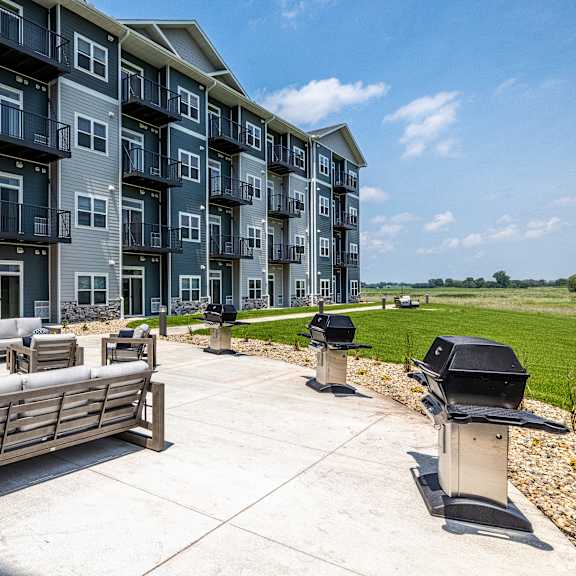 a sunny day at the outdoor seating area of a modern apartment complex.