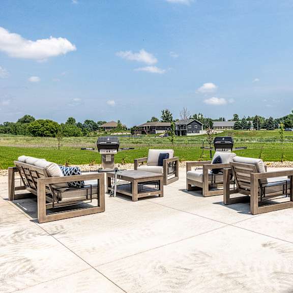 a set of outdoor furniture is arranged on a patio.