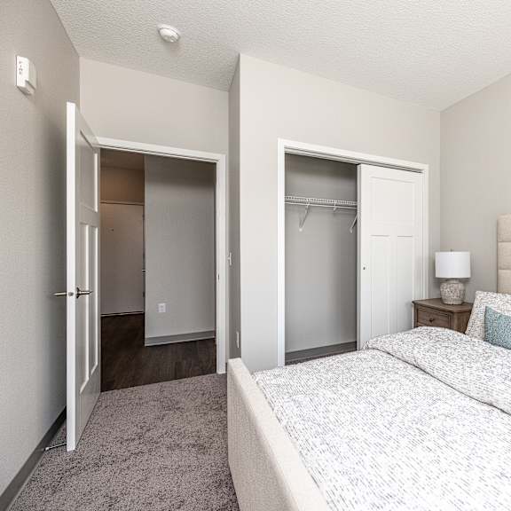 a bedroom with a large bed and two closets.