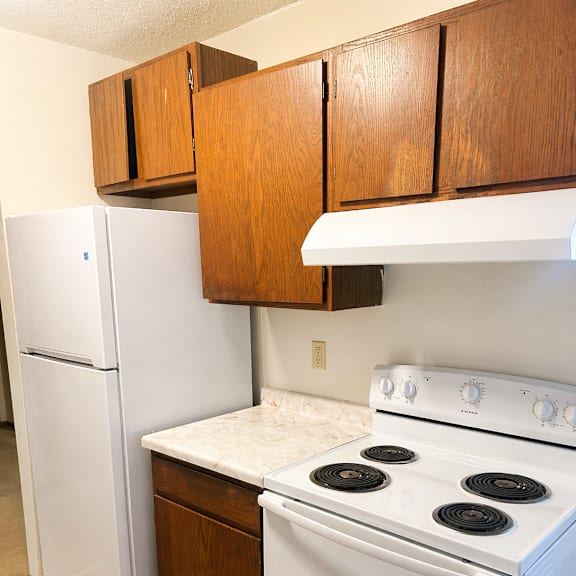a white fridge and stove in a kitchen.