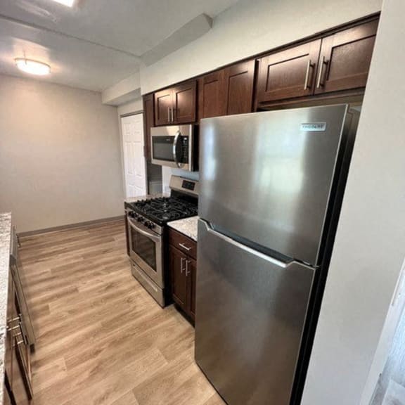 a kitchen with a stainless steel refrigerator