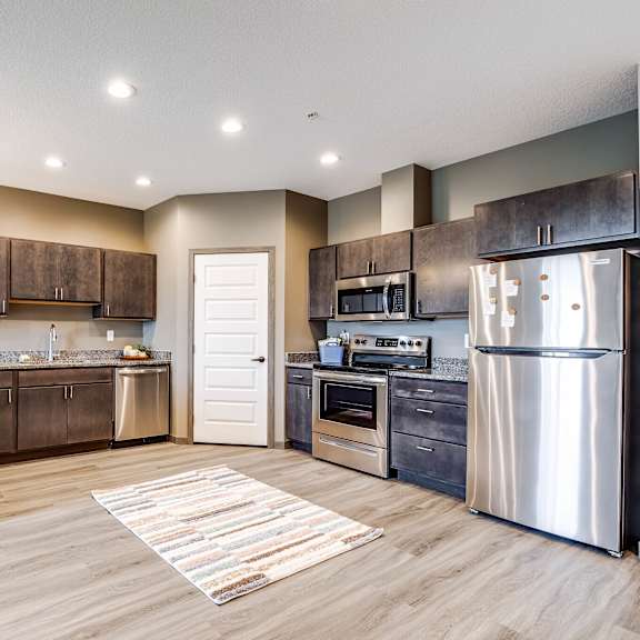 a kitchen with stainless steel appliances and wooden cabinets