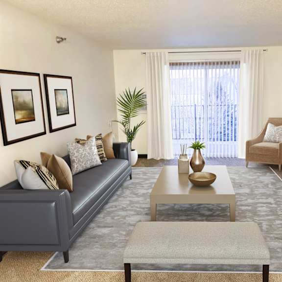 a living room with a grey couch, a coffee table, and a television.