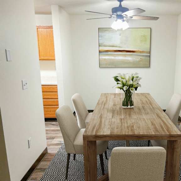 a dining room with a wooden table and chairs.
