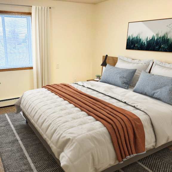 a bedroom with a large bed and a potted plant.