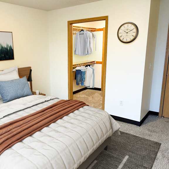 a bedroom with a large bed and a wardrobe.