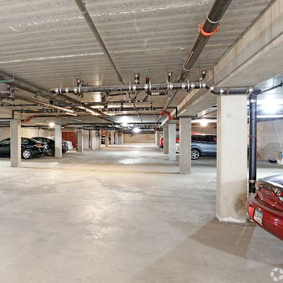 a large, empty parking garage with concrete floors and multiple columns.