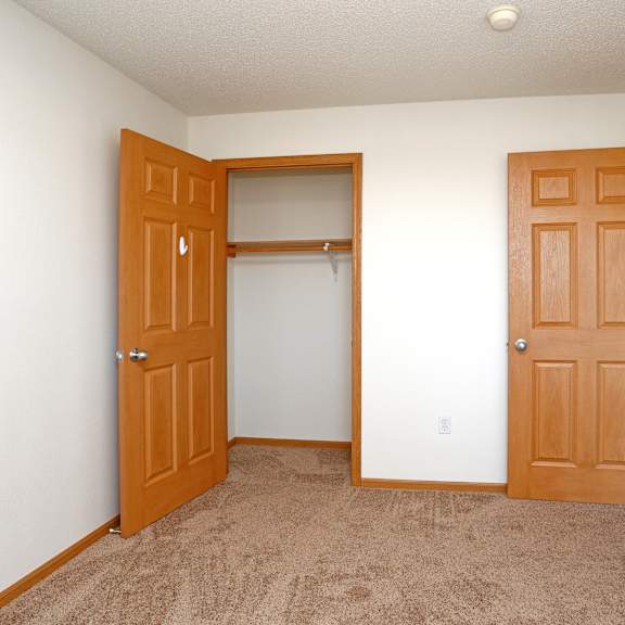 a room with two doors and a carpeted floor.