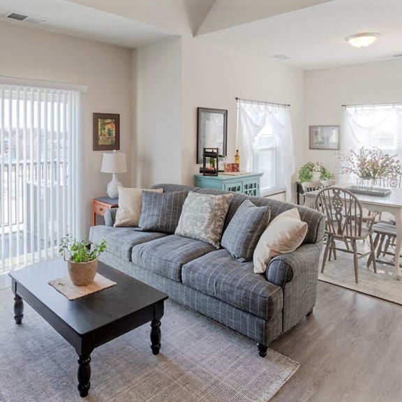 a living room and dining room with a couch and a table